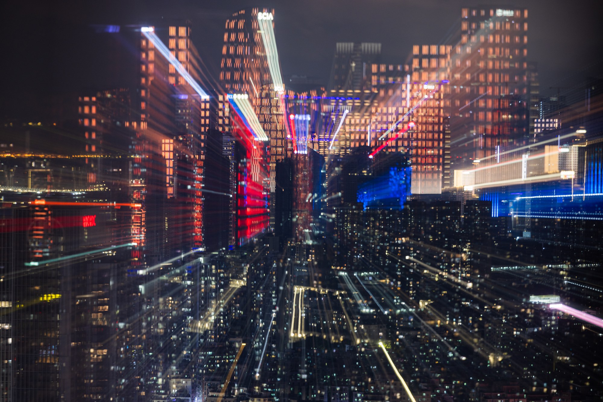 Megacity at night with dense light trails between the skyscrapers, China