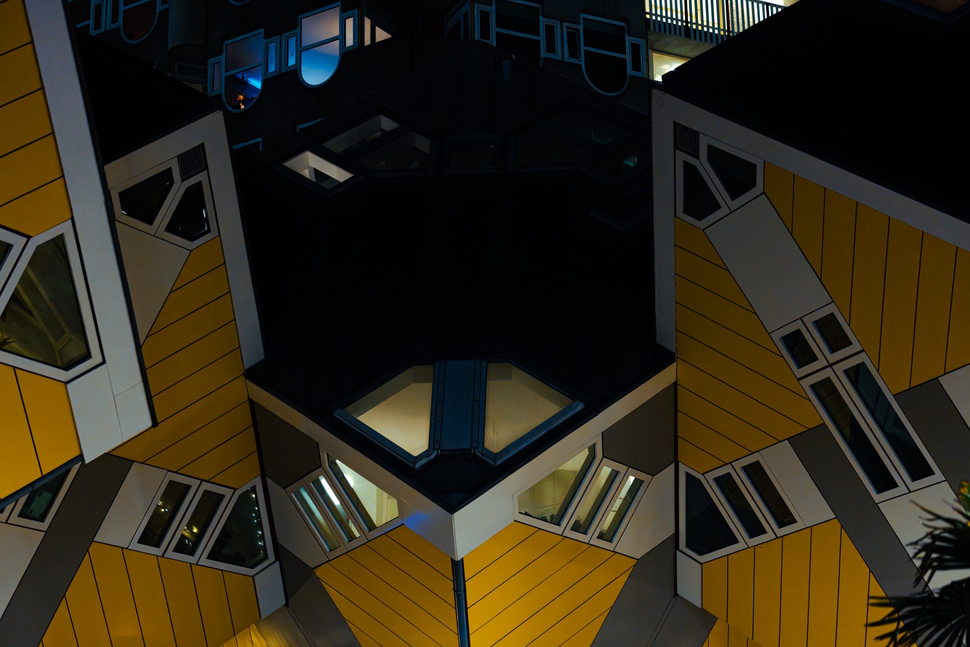 The yellow cube houses of Rotterdam, geometric against the dark evening sky