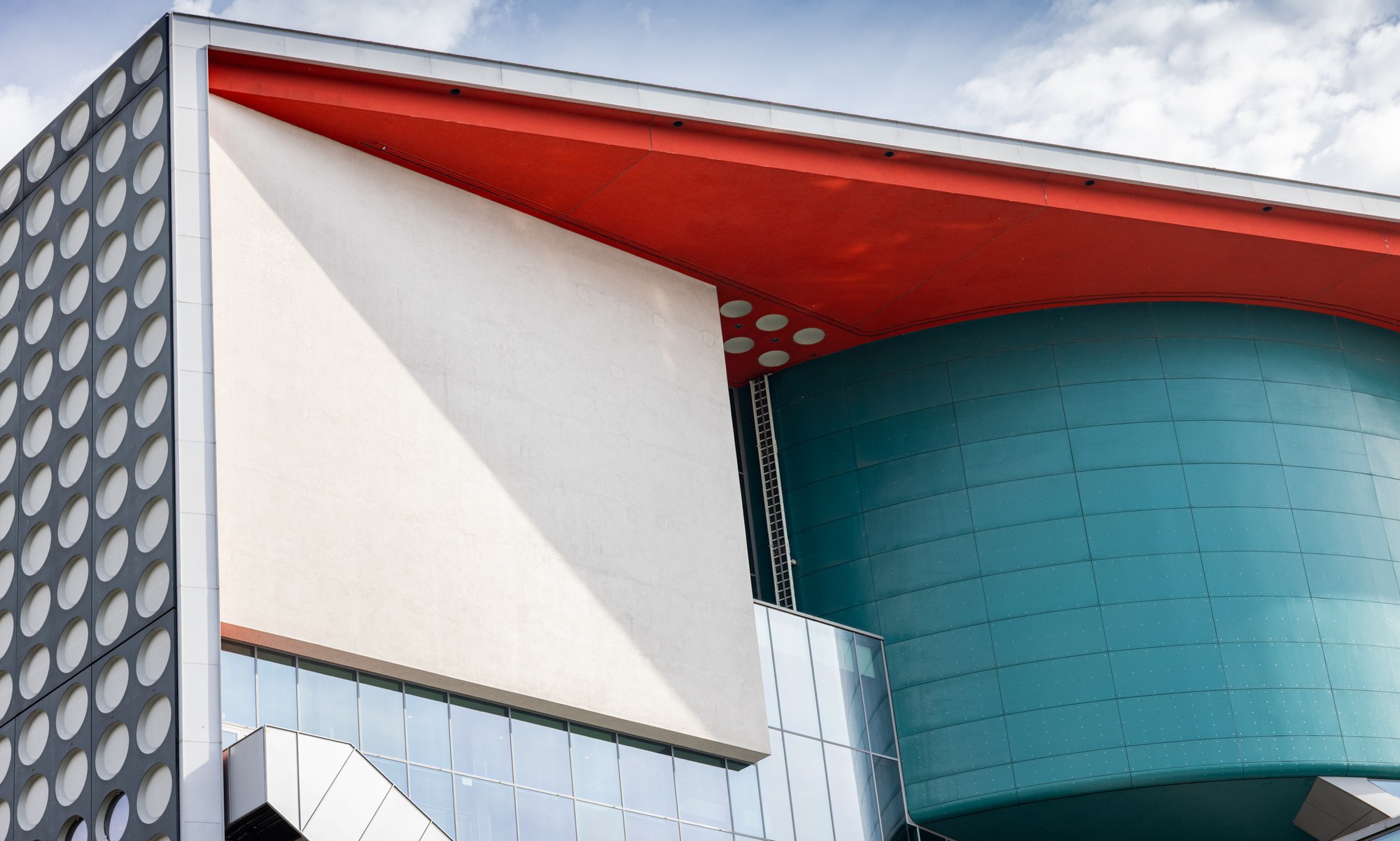 Red and teal curved architecture of TivoliVredenburg, Utrecht