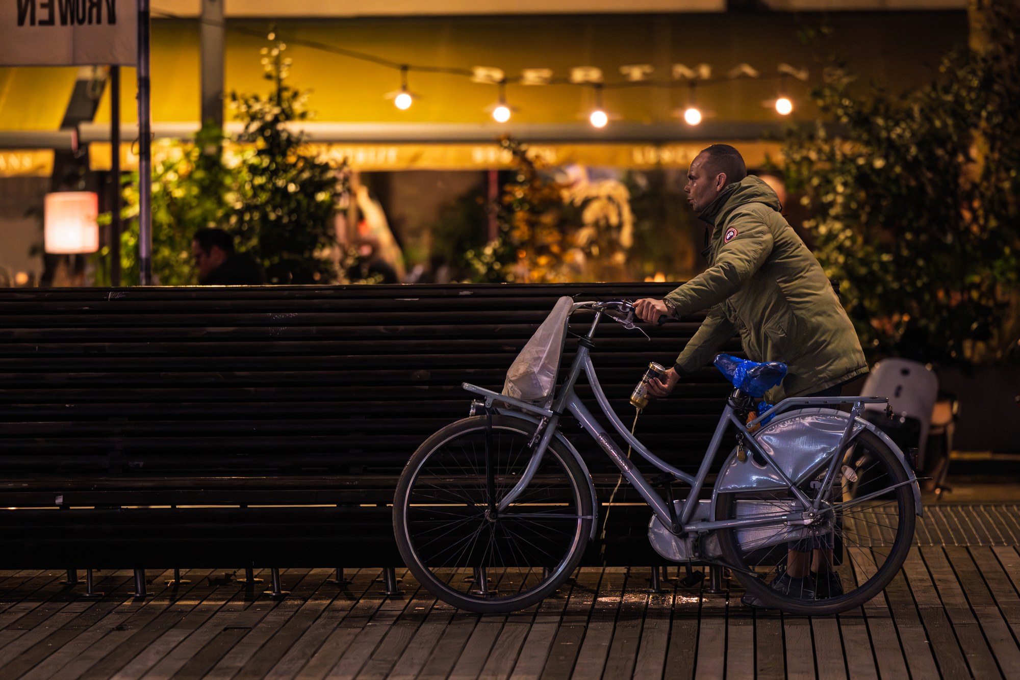Cyclist silhouetted against a warmly lit facade at night, Netherlands